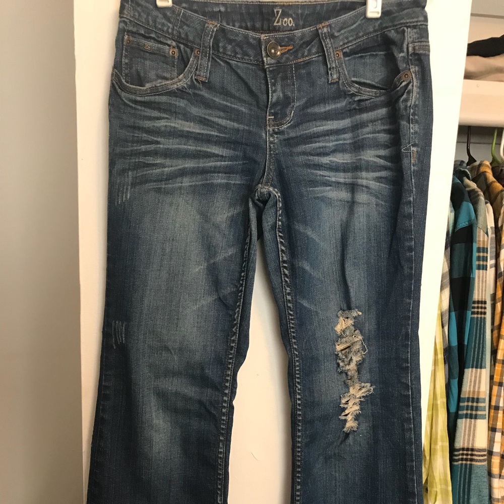 Dark Jeans with rips in them .
